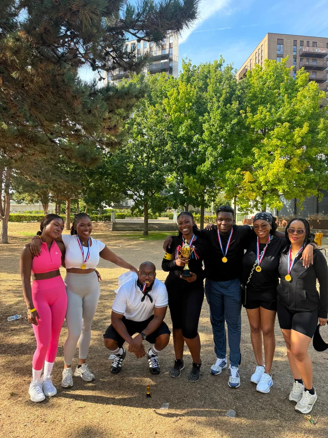 Summer Games players in a sunny park wearing their medals